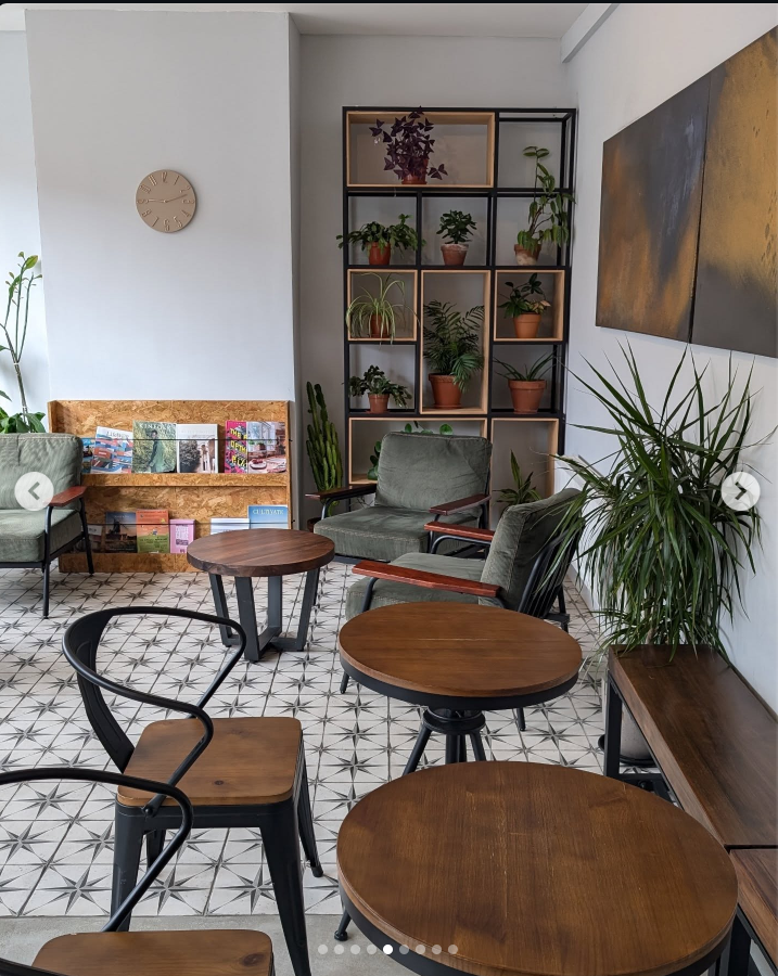 The shop at Shou: green chairs, wooden tables, plants and patterned tiles